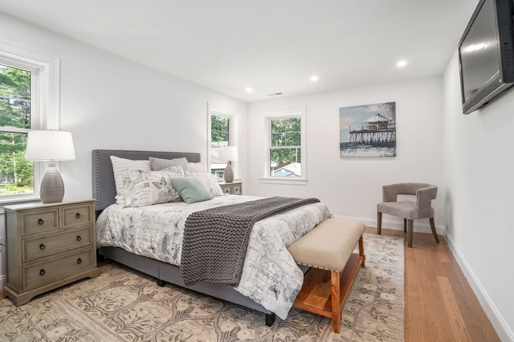 504 Hudson Road Sudbury, MA 01776 - Photo 23 of 42 a spacious bedroom with a bed and a couch