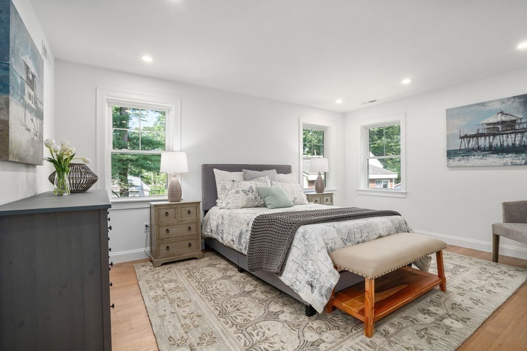 504 Hudson Road Sudbury, MA 01776 - Photo 24 of 42 a bedroom with a bed and wooden floor