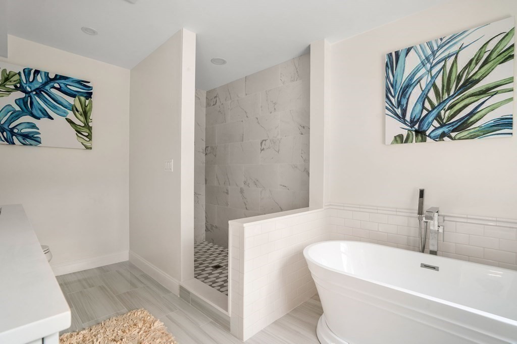 504 Hudson Road Sudbury, MA 01776 - Photo 27 of 42 a bathroom with a bathtub and a sink