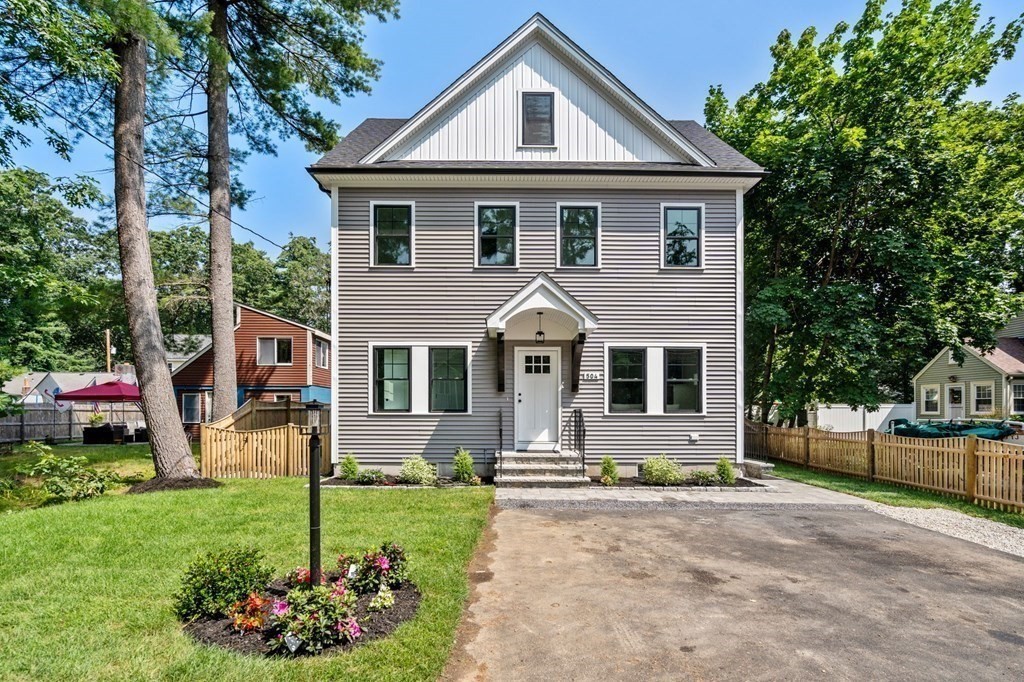 504 Hudson Road Sudbury, MA 01776 - Photo 3 of 42 a front view of a house with a yard and porch