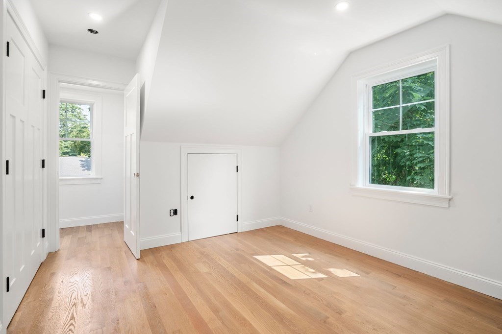 504 Hudson Road Sudbury, MA 01776 - Photo 31 of 42 an empty room with wooden floor and windows