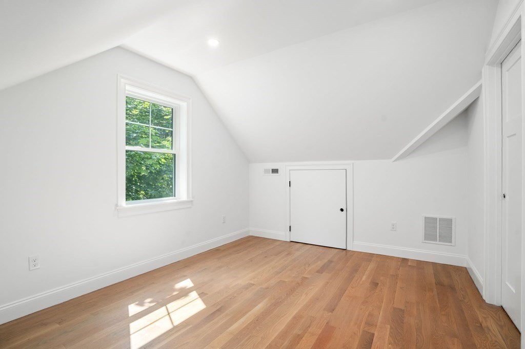 504 Hudson Road Sudbury, MA 01776 - Photo 32 of 42 an empty room with wooden floor and windows
