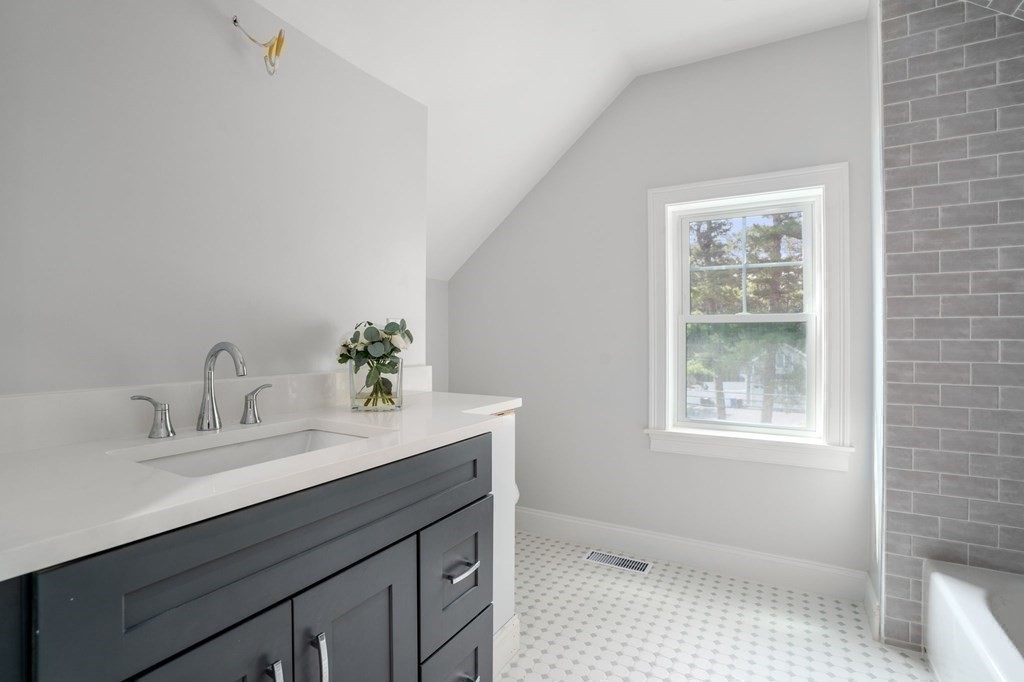 504 Hudson Road Sudbury, MA 01776 - Photo 33 of 42 a bathroom with a sink vanity granite and a mirror