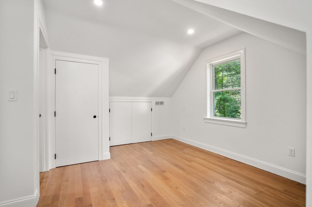 504 Hudson Road Sudbury, MA 01776 - Photo 34 of 42 an empty room with wooden floor and windows