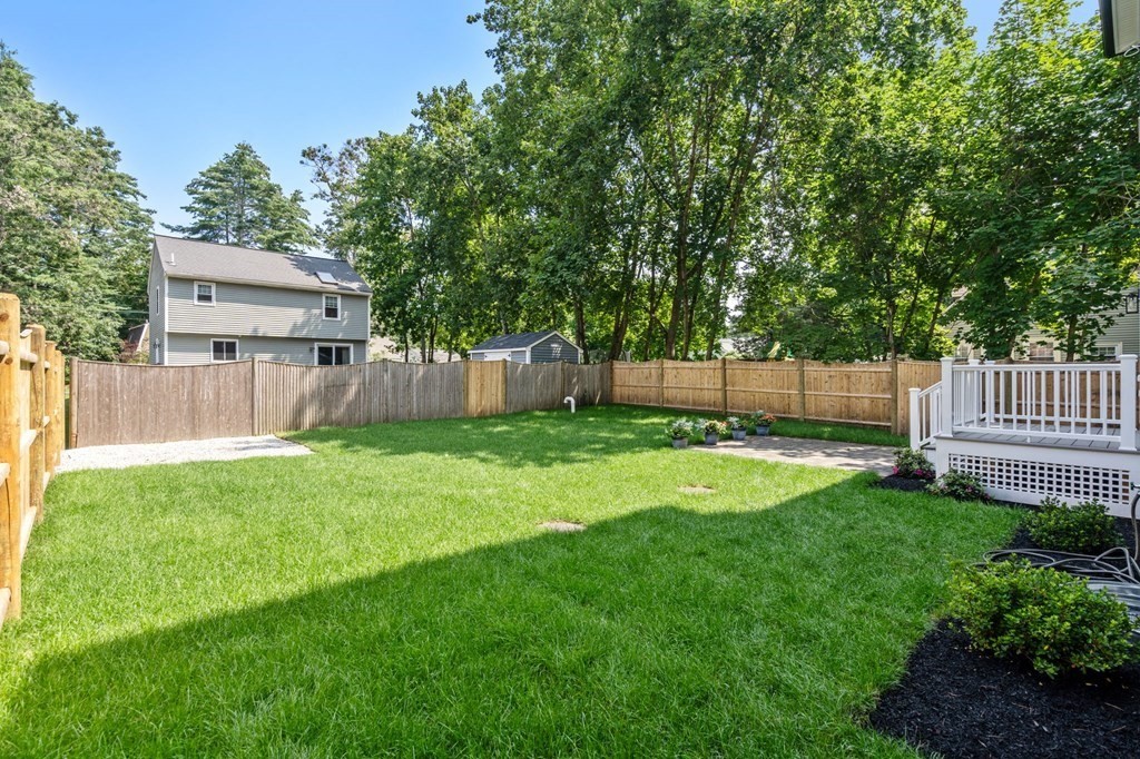 504 Hudson Road Sudbury, MA 01776 - Photo 39 of 42 a view of a backyard with a garden and tree