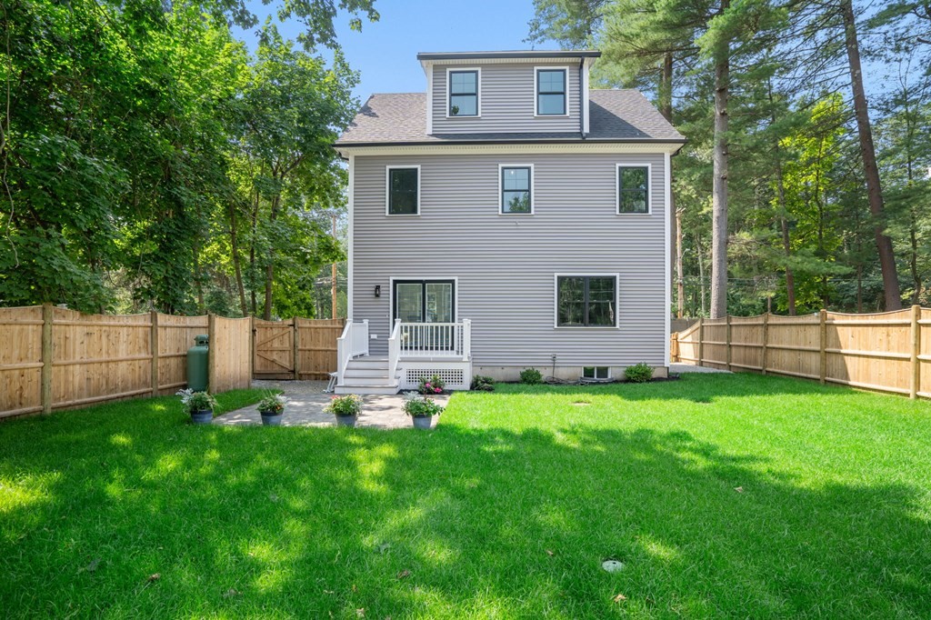 504 Hudson Road Sudbury, MA 01776 - Photo 40 of 42 a front view of a house with a yard