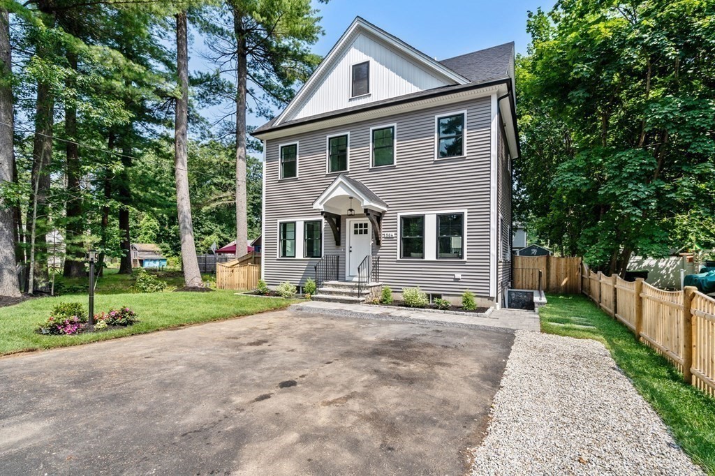 504 Hudson Road Sudbury, MA 01776 - Photo 4 of 42 a front view of a house with a yard and trees