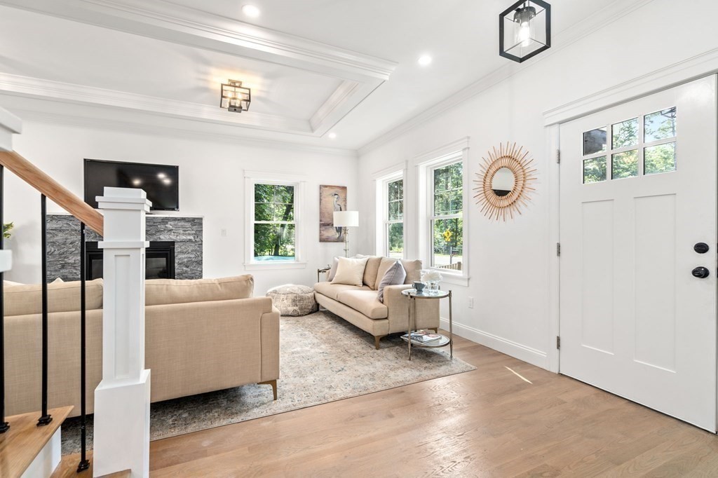 504 Hudson Road Sudbury, MA 01776 - Photo 5 of 42 a living room with furniture and a fireplace