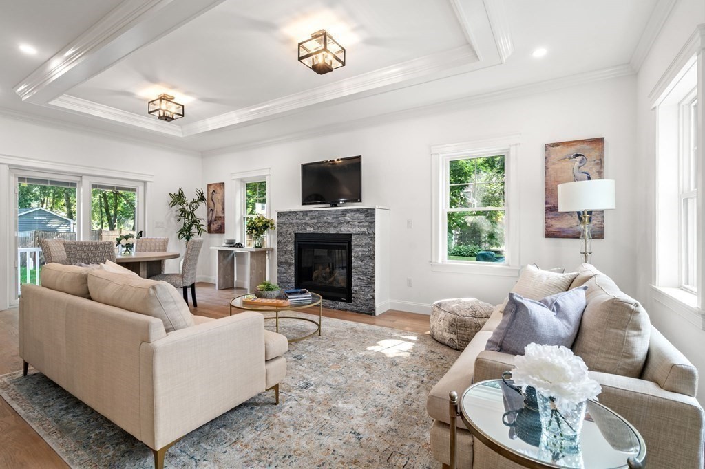 504 Hudson Road Sudbury, MA 01776 - Photo 6 of 42 a living room with furniture a large window and a fireplace