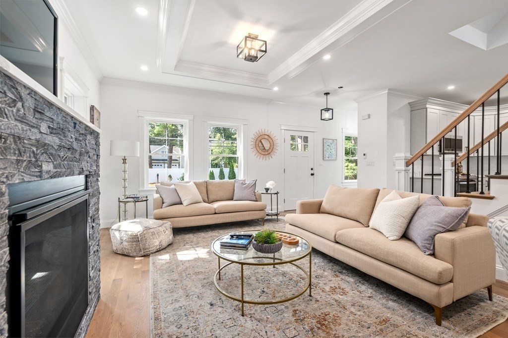 504 Hudson Road Sudbury, MA 01776 - Photo 8 of 42 a living room with furniture a large window and a fireplace
