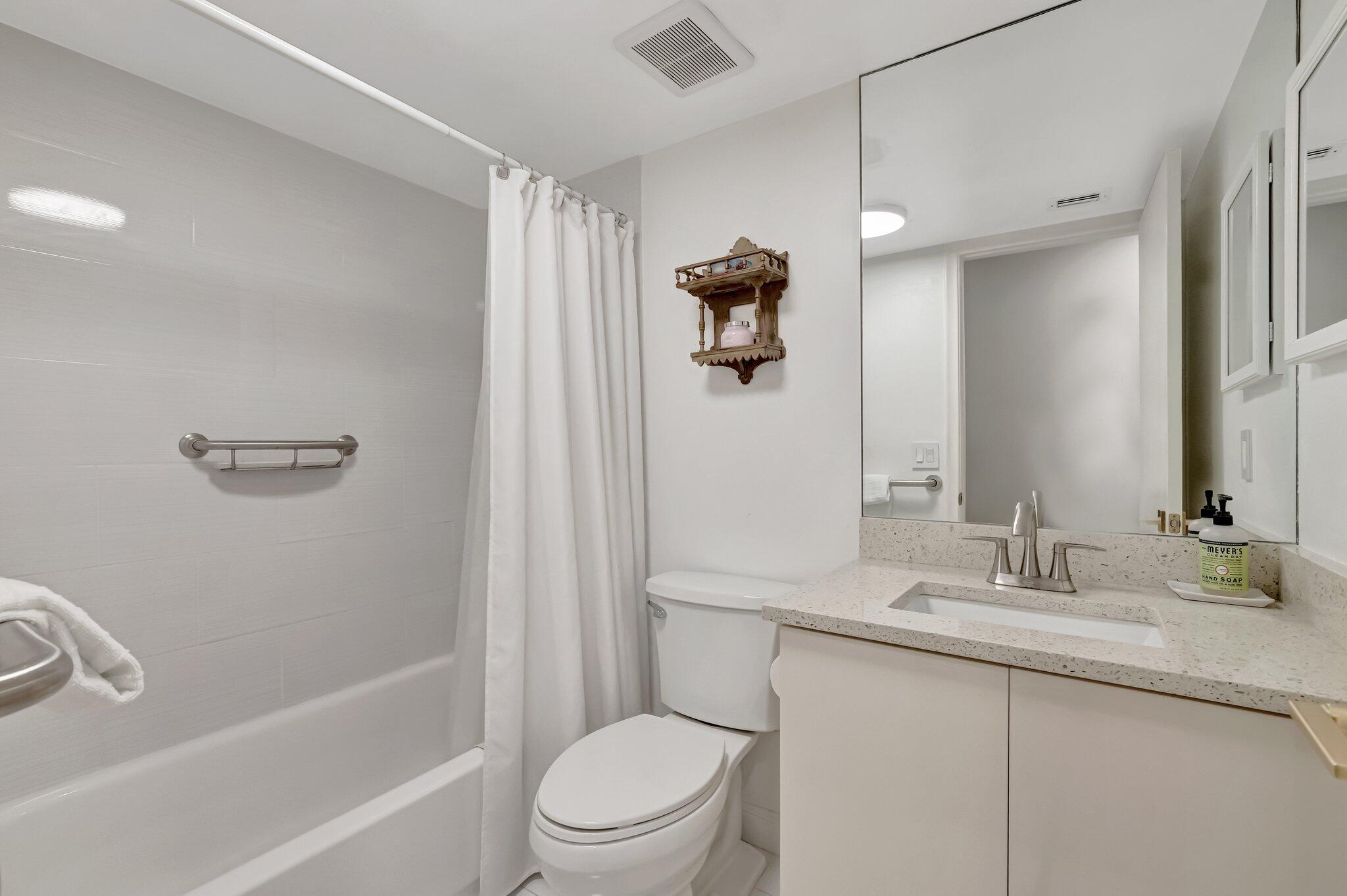 3310 Bridgewood Drive Boca Raton, FL 33434 - Photo 15 of 24 a bathroom with a granite countertop sink a toilet and shower