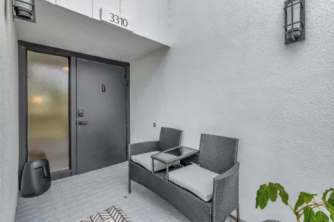 a view of a living room and washer and dryer