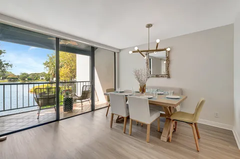 a view of a water pond with palm trees
