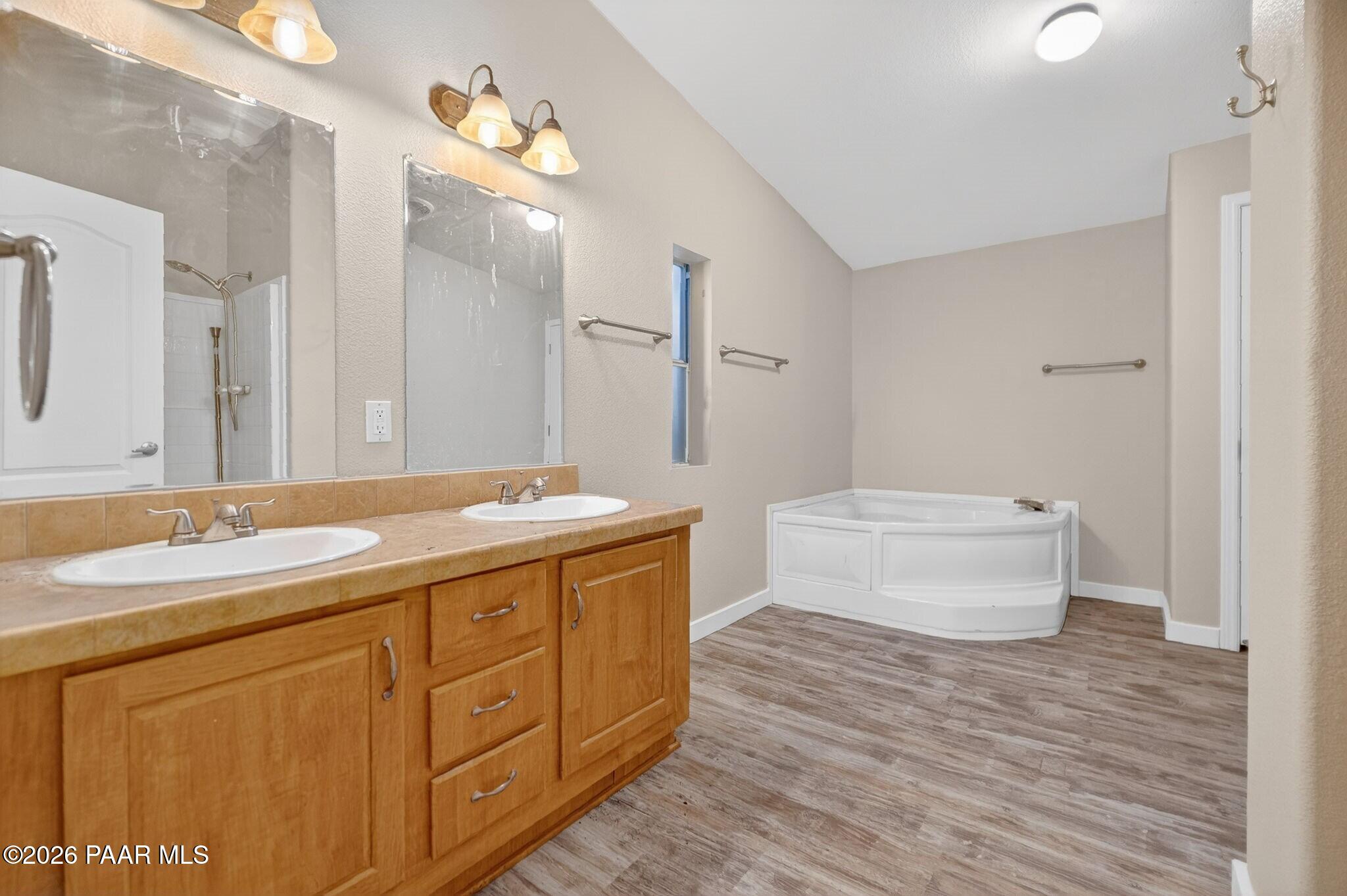 13230 East Main Street Mayer, AZ 86333 - Photo 12 of 32 a spacious bathroom with a granite countertop sink a toilet and a mirror