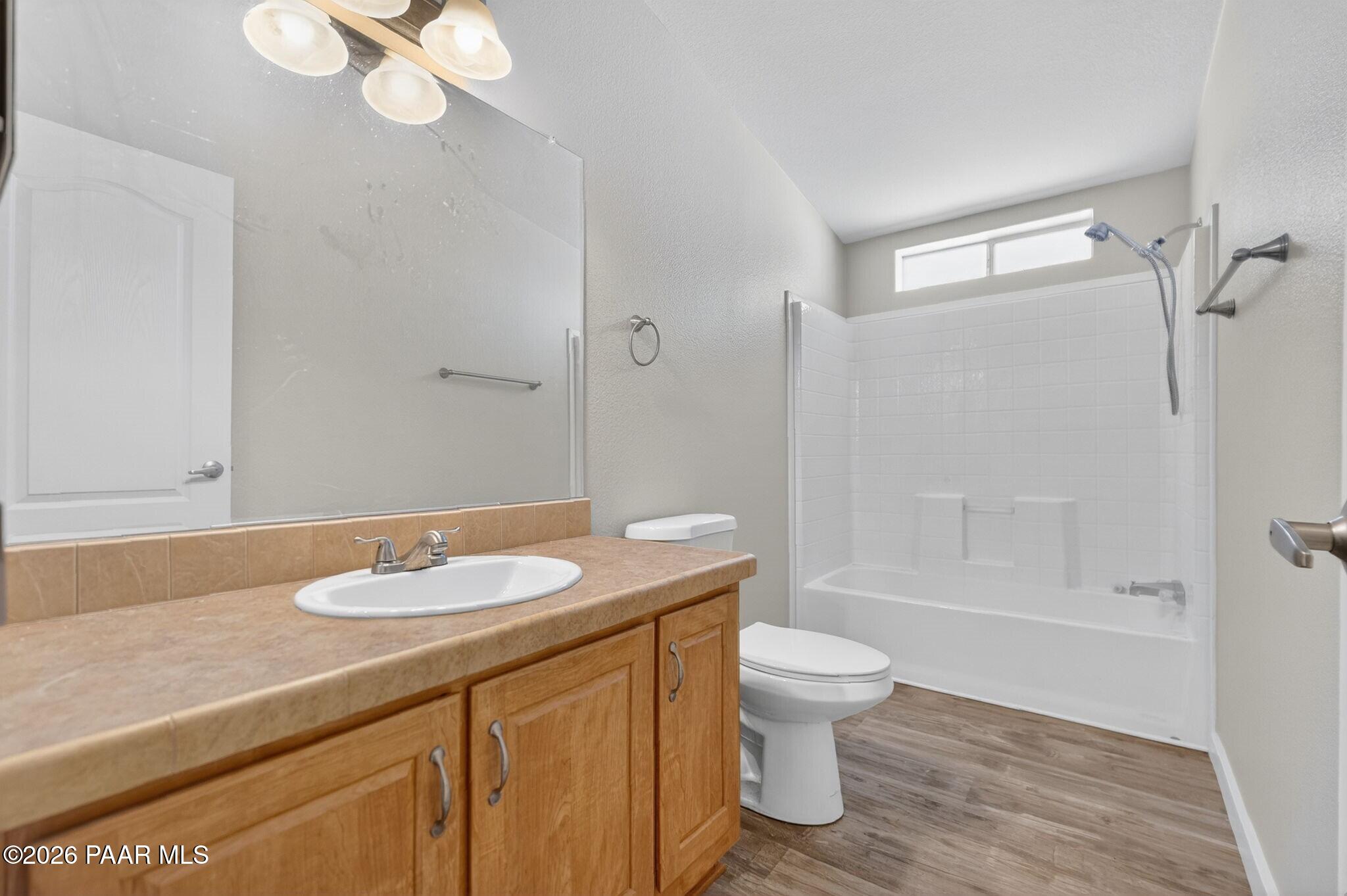 13230 East Main Street Mayer, AZ 86333 - Photo 23 of 32 a bathroom with a granite countertop sink toilet and shower