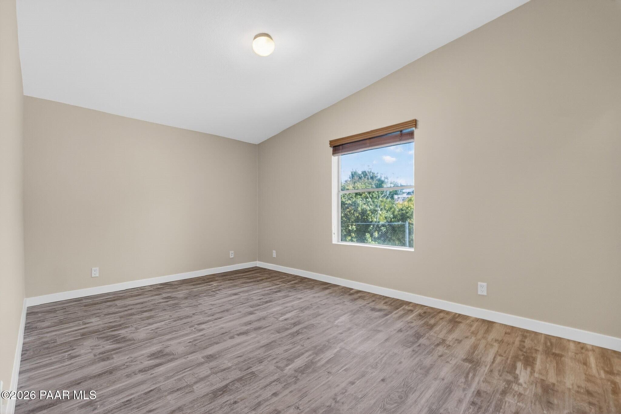 13230 East Main Street Mayer, AZ 86333 - Photo 25 of 32 an empty room with wooden floor and windows