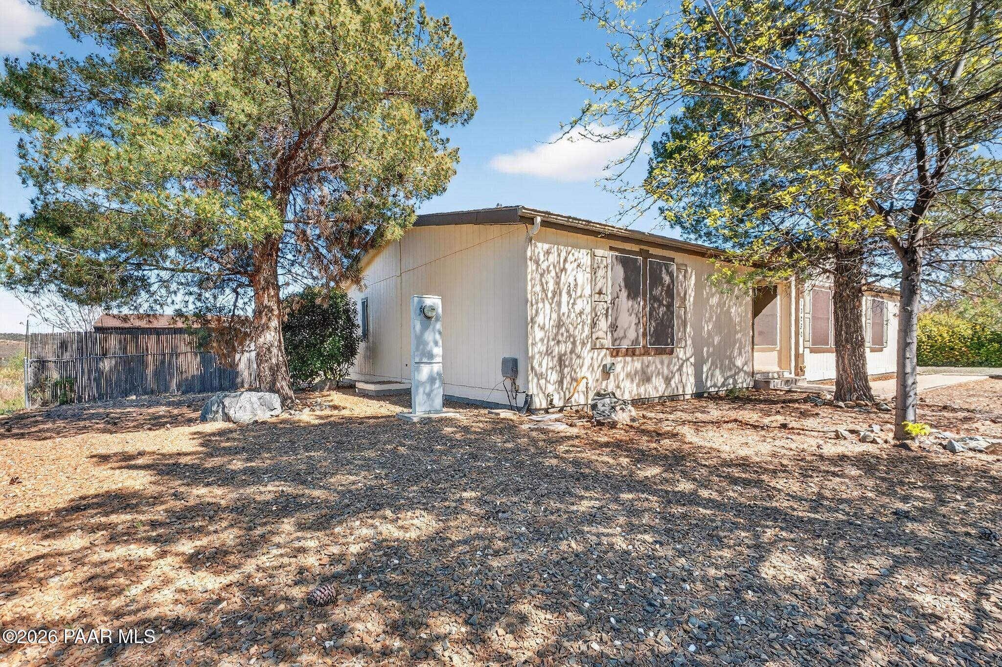 13230 East Main Street Mayer, AZ 86333 - Photo 27 of 32 a front view of a house with a yard and garage