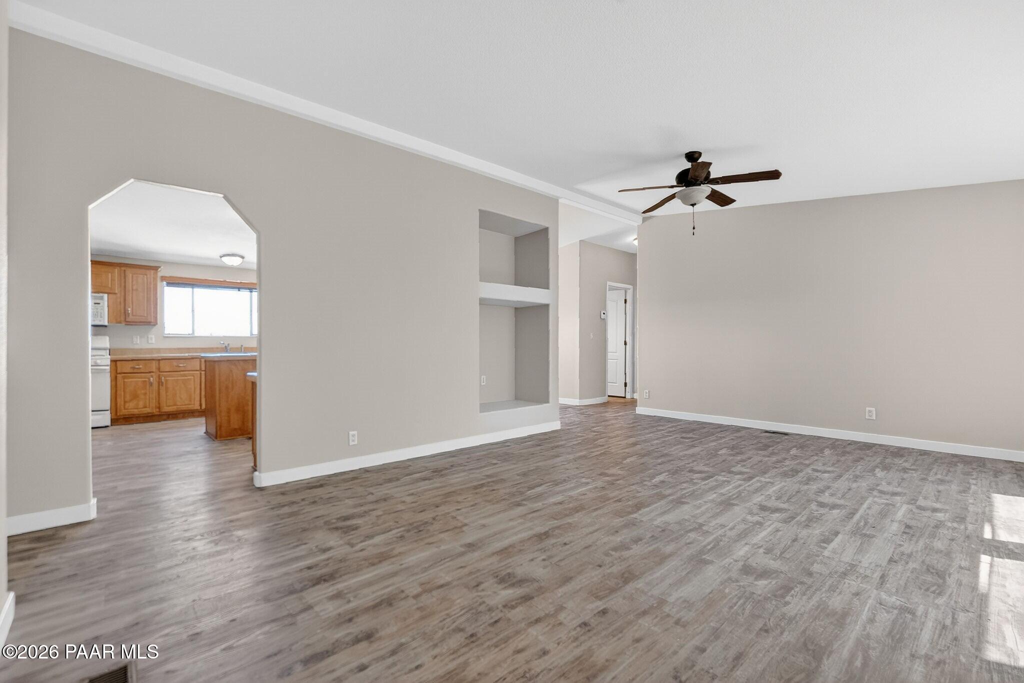 13230 East Main Street Mayer, AZ 86333 - Photo 6 of 32 a view of a livingroom with wooden floor and a ceiling fan