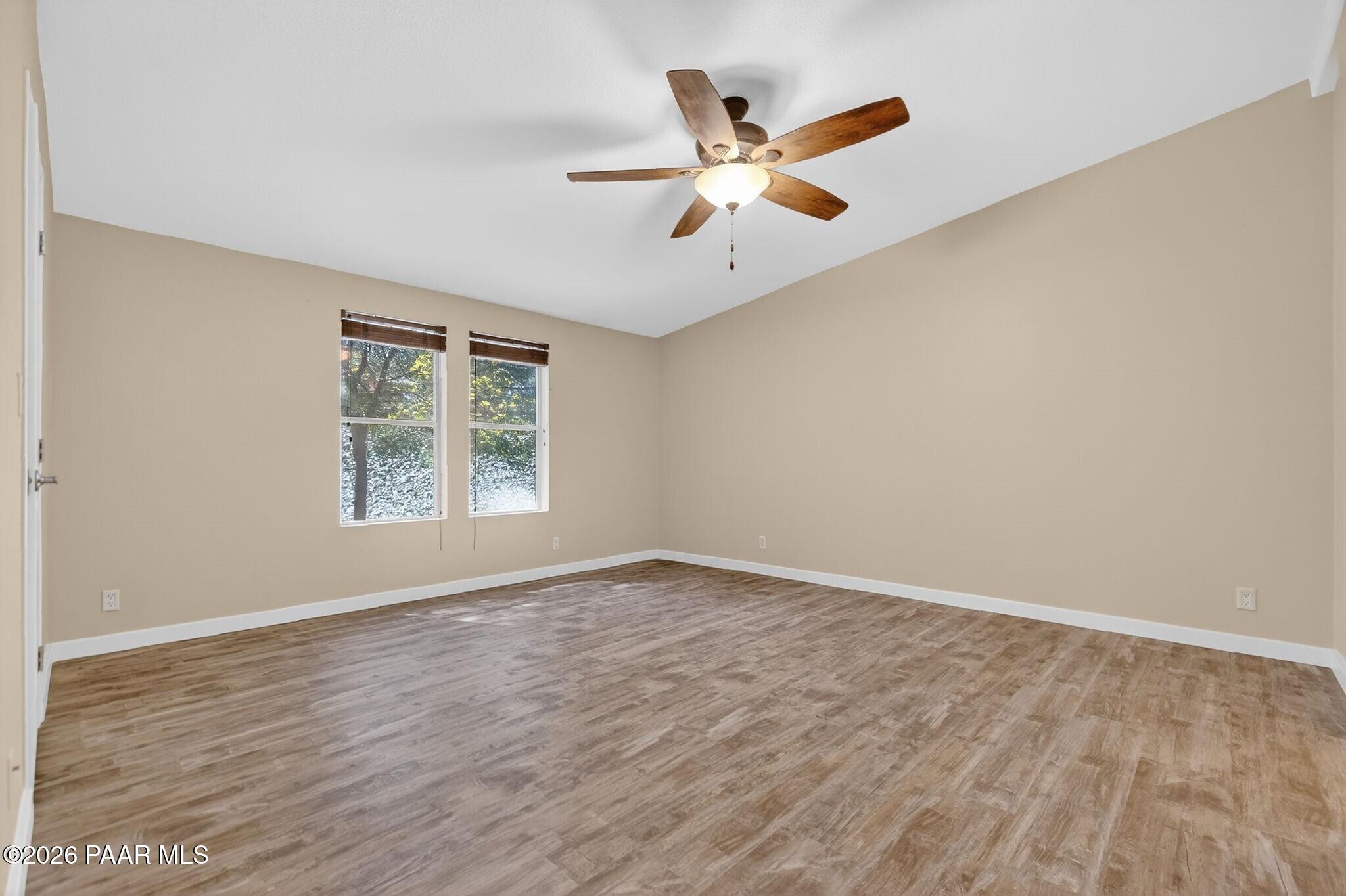 13230 East Main Street Mayer, AZ 86333 - Photo 10 of 32 an empty room with wooden floor fan and windows