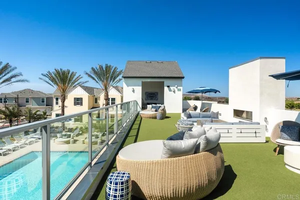 a view of a house with swimming pool and furniture