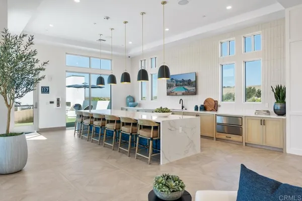a kitchen with a table a sink and a stove with wooden floor
