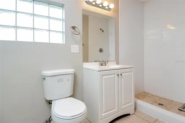 a white toilet sitting next to a bathroom sink