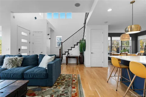 an open kitchen with dining table and stainless steel appliances