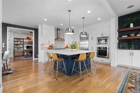 a kitchen with stainless steel appliances a sink stove refrigerator and cabinets
