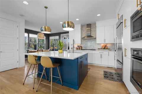 a dining room with furniture a chandelier and wooden floor