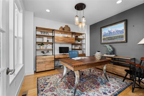 a view of a dining room with furniture wooden floor and chandelier