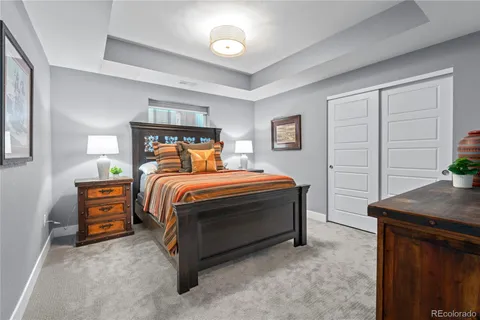 a bedroom with furniture and a flat screen tv