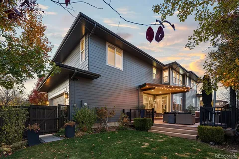 a view of a house with a fountain and sitting area