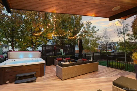 a roof deck with couches and wooden floor