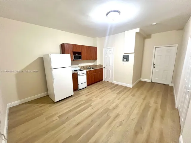 a view of kitchen and wooden floor