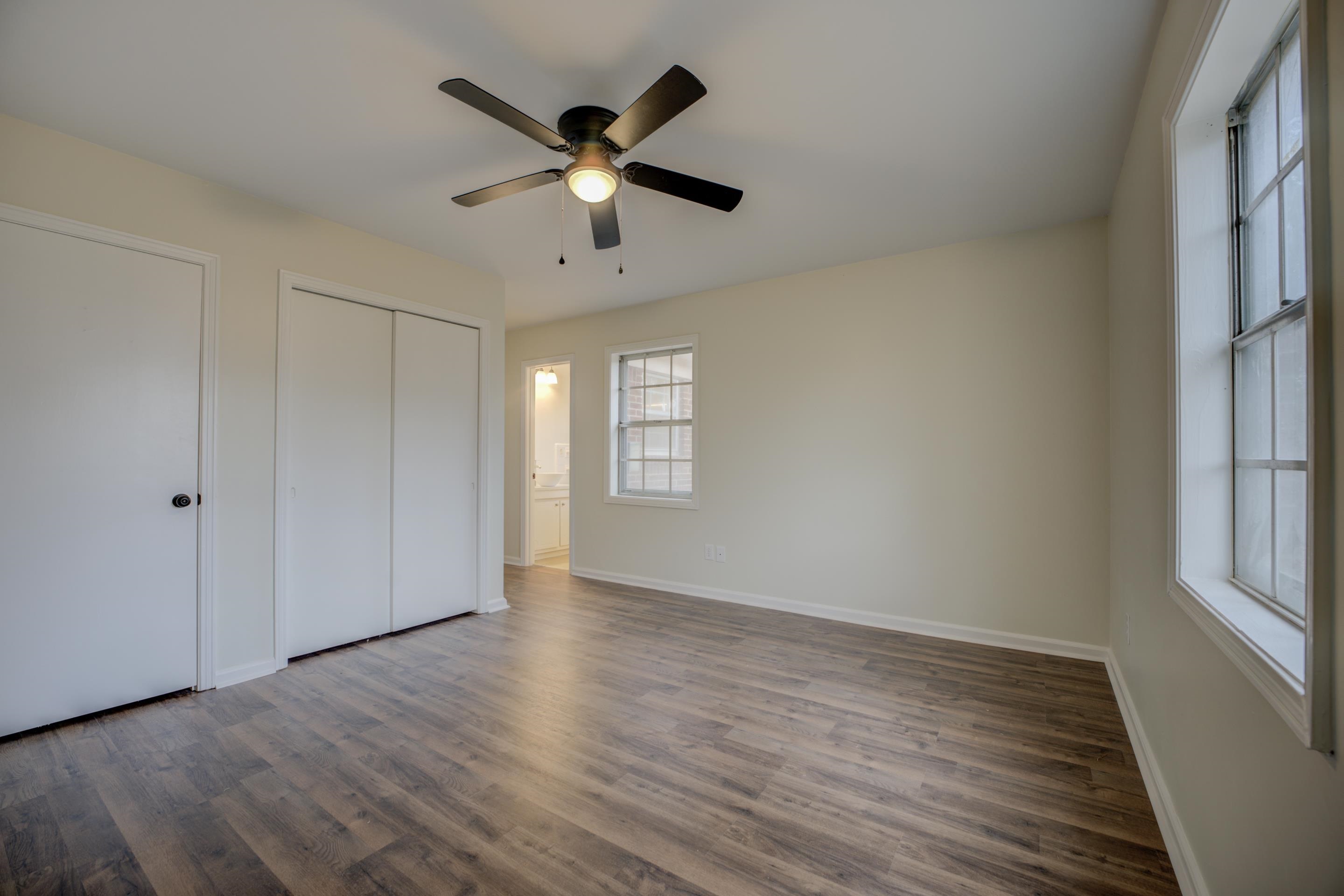 5731 Foxdale Road Memphis, TN 38115 - Photo 17 of 27 Unfurnished bedroom featuring dark hardwood / wood-style floors, ceiling fan, and multiple closets