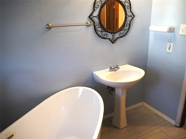 a white bath tub sitting in a bathroom