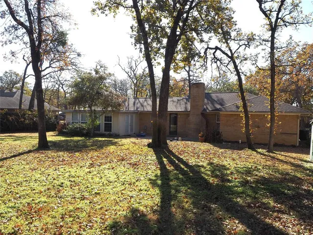 a view of a house with a yard covered with snow