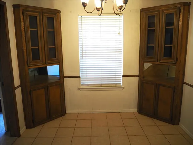 a view of an empty room with a fireplace and a window
