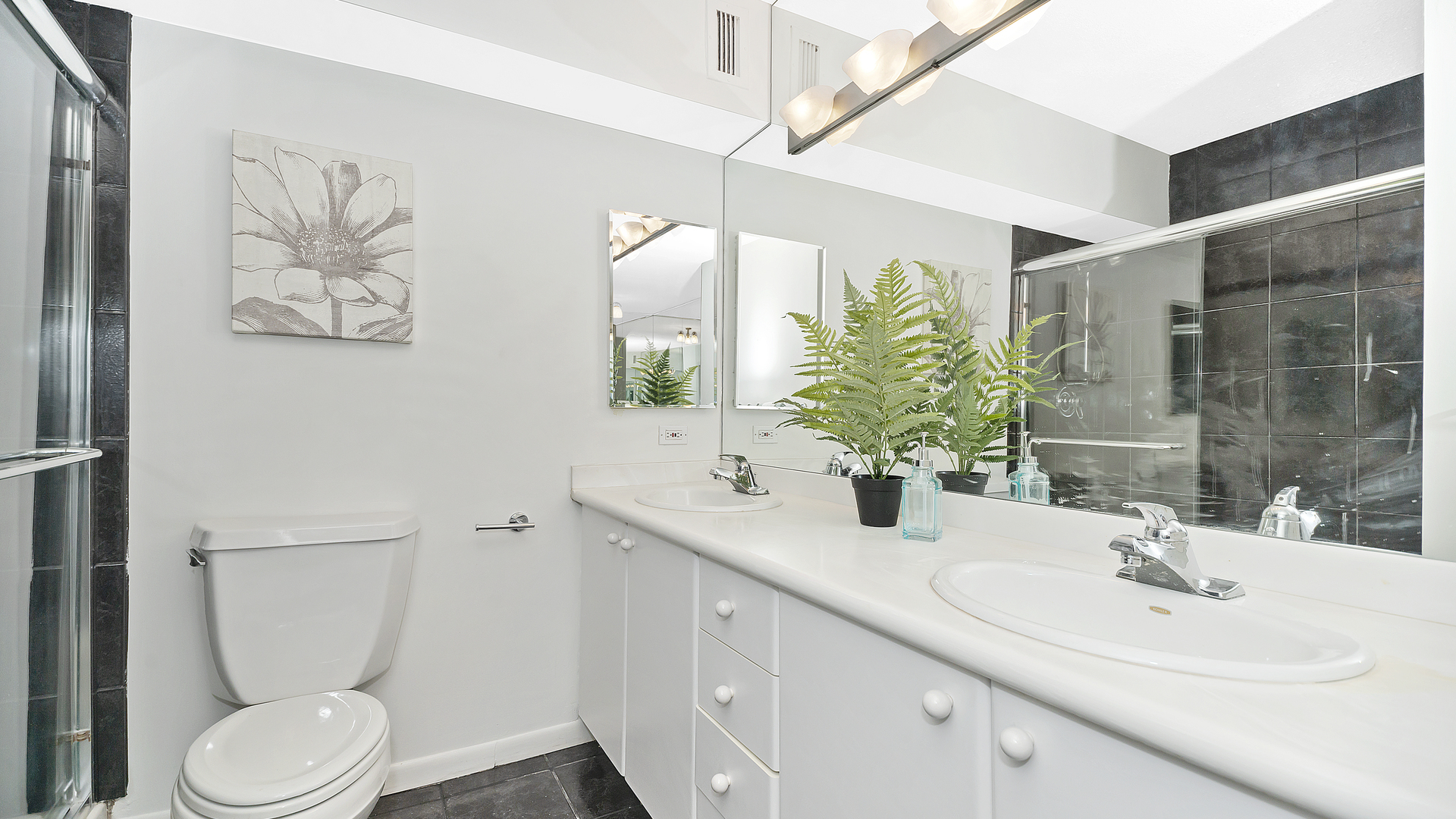 1313 North Ritchie Court, Unit 2405 Chicago, IL 60610 - Photo 14 of 26 a bathroom with a toilet sink and mirror