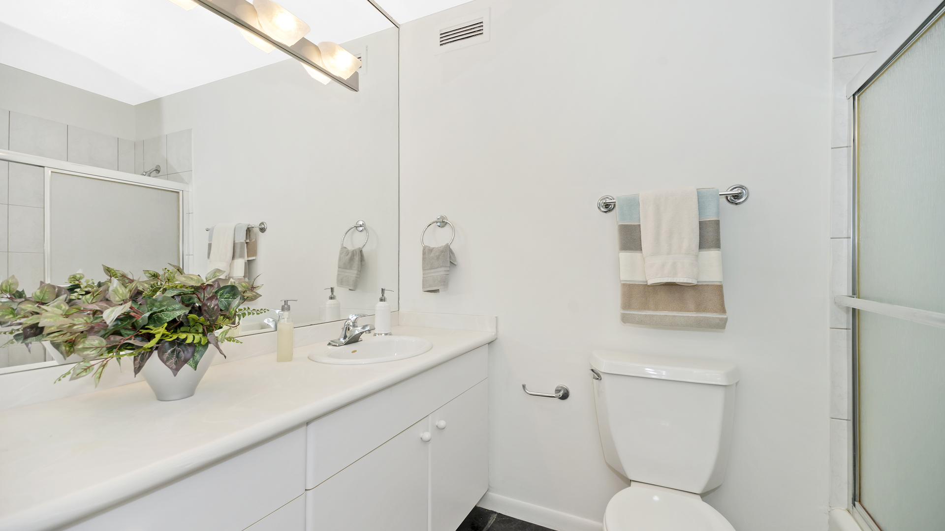 1313 North Ritchie Court, Unit 2405 Chicago, IL 60610 - Photo 19 of 26 a bathroom with a sink a toilet and a mirror