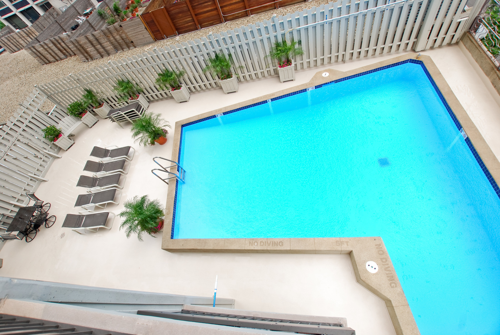 1313 North Ritchie Court, Unit 2405 Chicago, IL 60610 - Photo 25 of 26 a view of a balcony with a chair and potted plants