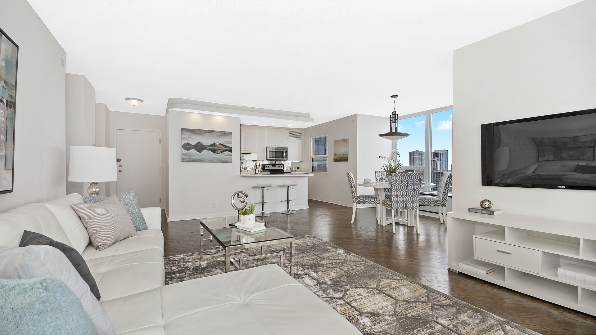 1313 North Ritchie Court, Unit 2405 Chicago, IL 60610 - Photo 4 of 26 a living room with furniture and a flat screen tv