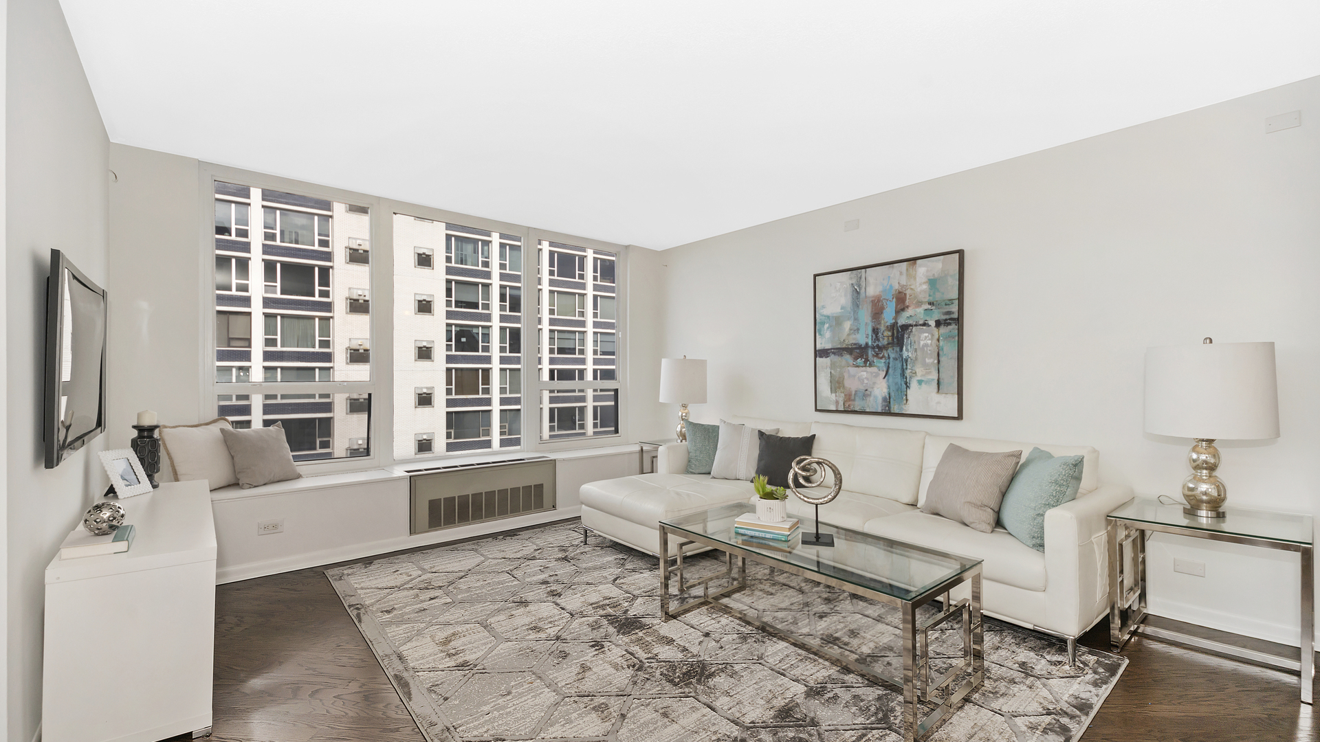 1313 North Ritchie Court, Unit 2405 Chicago, IL 60610 - Photo 5 of 26 a living room with furniture and a flat screen tv