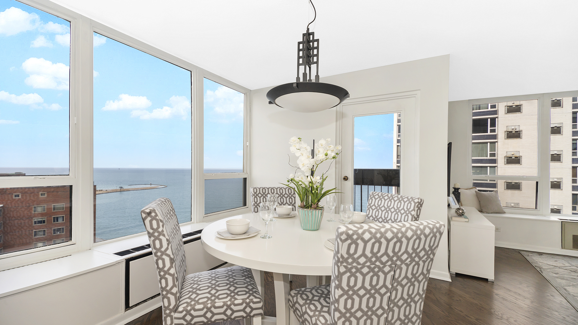 1313 North Ritchie Court, Unit 2405 Chicago, IL 60610 - Photo 6 of 26 a view of a dining room with furniture window and wooden floor