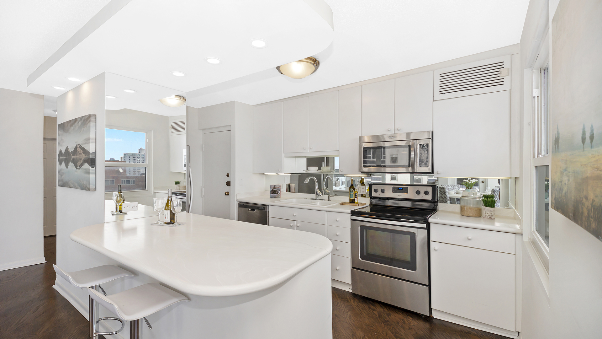 1313 North Ritchie Court, Unit 2405 Chicago, IL 60610 - Photo 7 of 26 a kitchen with a sink stainless steel appliances and white cabinets
