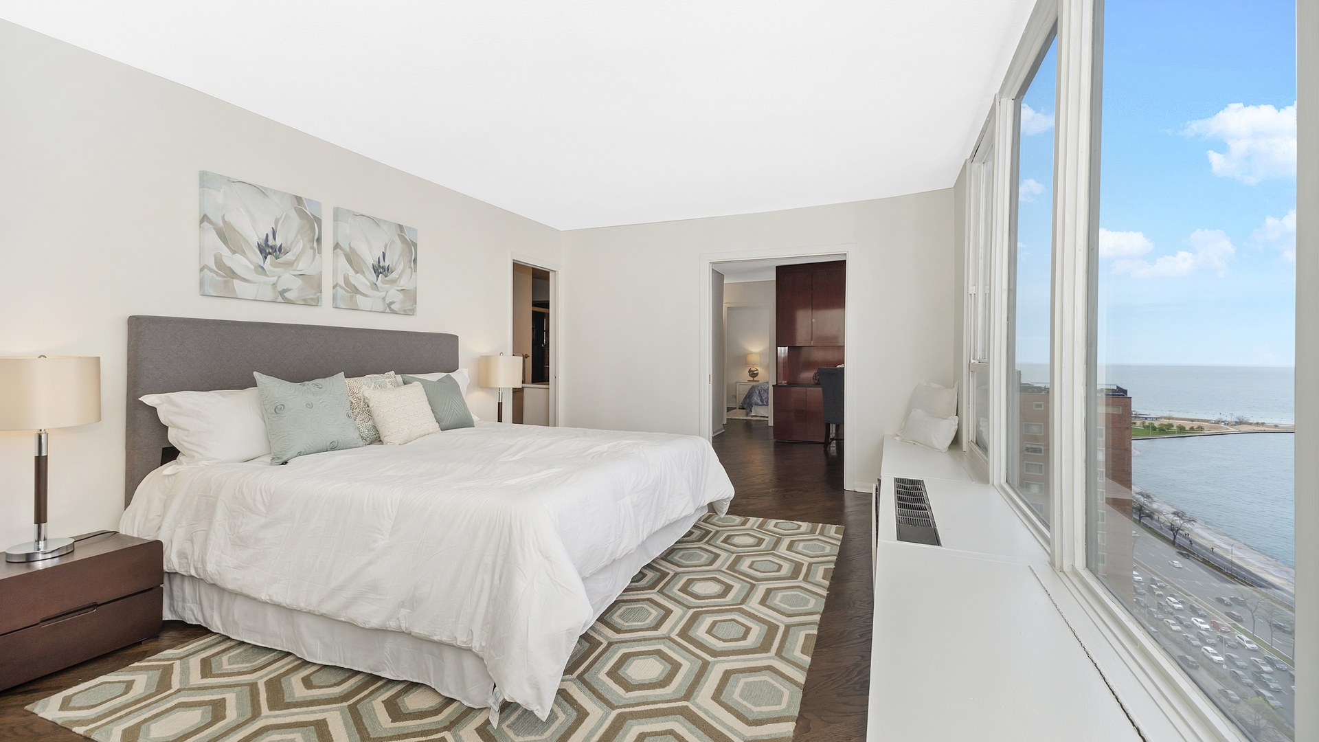 1313 North Ritchie Court, Unit 2405 Chicago, IL 60610 - Photo 10 of 26 a spacious bedroom with a bed and glass door