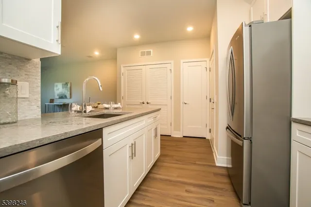 a bathroom with a double vanity sink and a large mirror