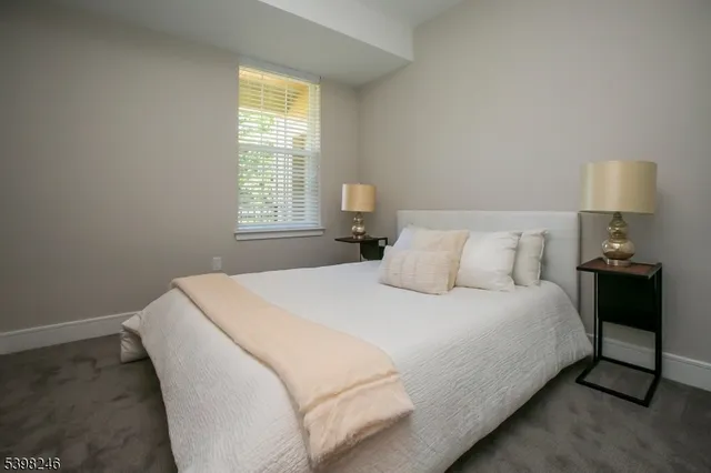 a bedroom with a bed and a lamp