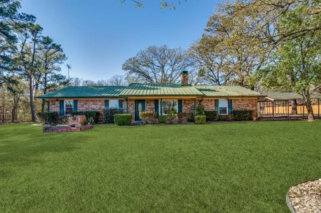 a view of a house with a yard and furniture