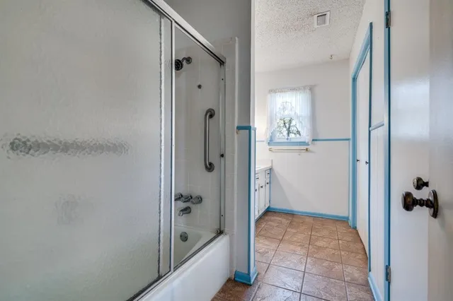 a bathroom with a tub and shower